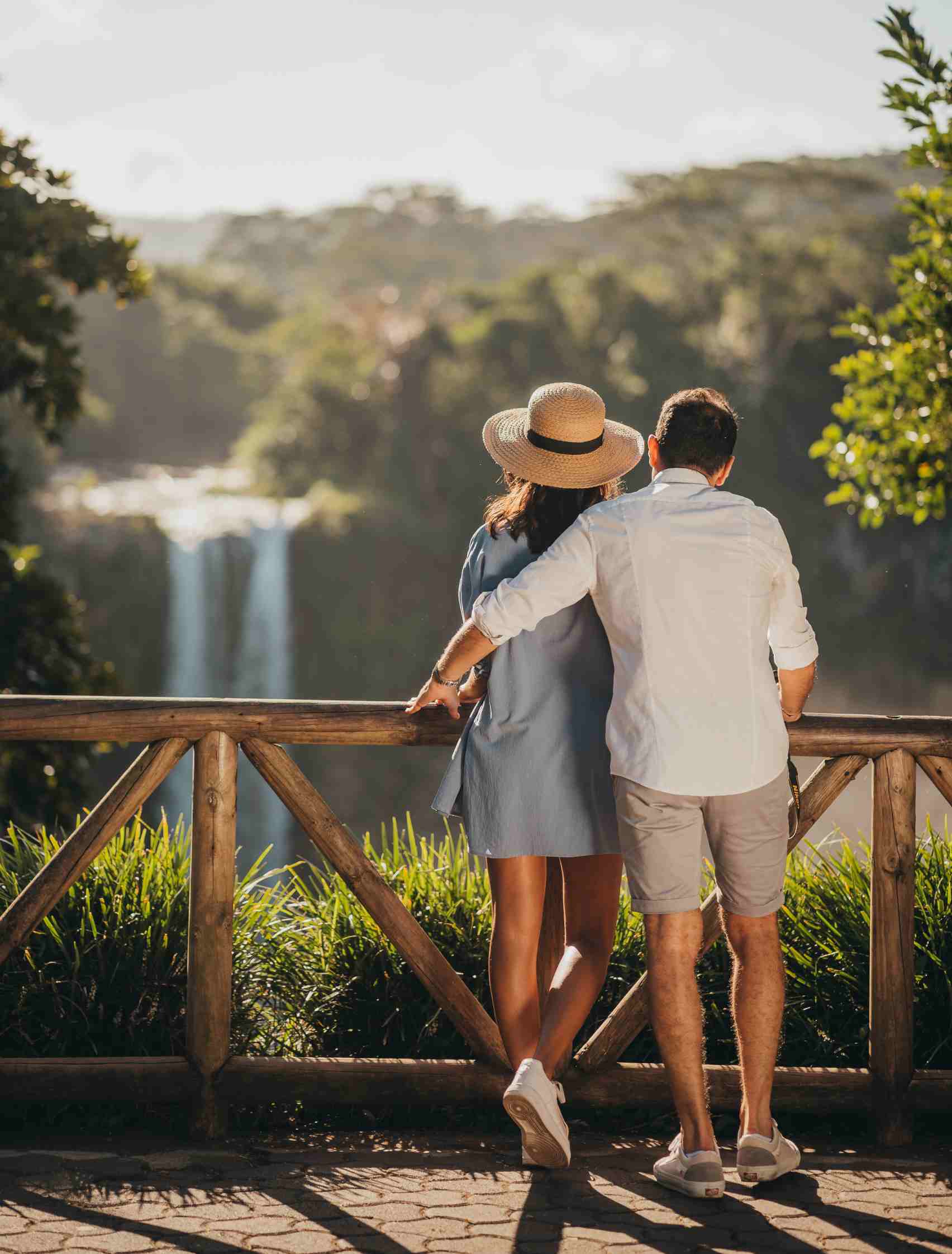 Couple Watching Waterfall From Viewpoint