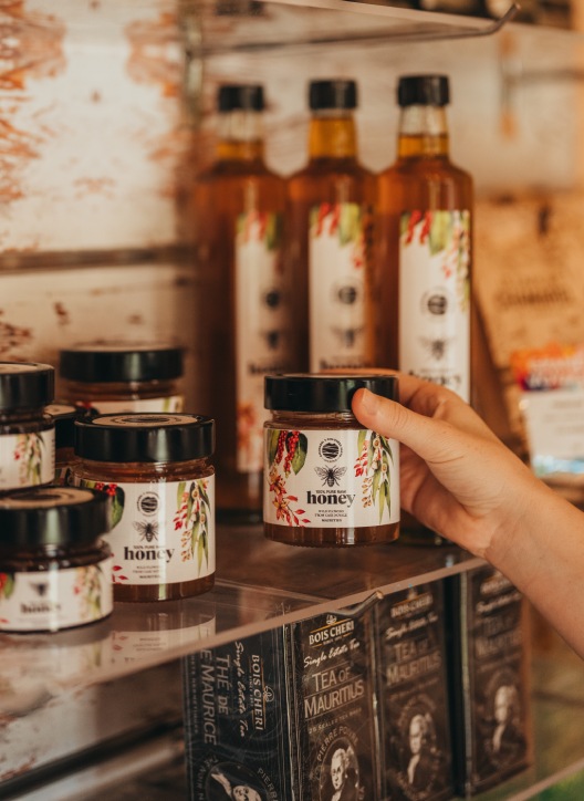 Hand Holding Honey Jar